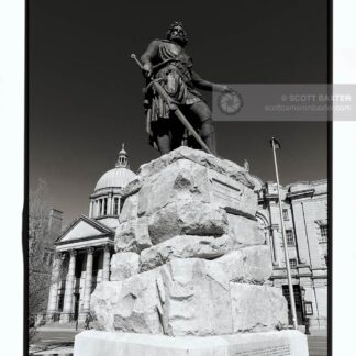 Photograph of William Wallace Statue in Aberdeen Scotland, Image is looking up at the statue which dominates the frame, the image is in upright portrait, black and white with the sun hitting the statue. Picture taken by Aberdeen photographer Scott Cameron Baxter.